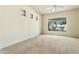 Spacious bedroom featuring a large window and neutral carpeting at 3830 E Carter Dr, Phoenix, AZ 85042
