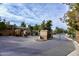 Gated community entrance with landscaping and signage at 3830 E Carter Dr, Phoenix, AZ 85042