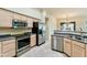 Kitchen with stainless steel appliances and light wood cabinets at 3830 E Carter Dr, Phoenix, AZ 85042