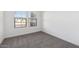 Well-lit bedroom with carpet and window looking outside at 3873 S 233Rd Ln, Buckeye, AZ 85326