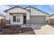 New construction home with a two-car garage and desert landscaping at 3873 S 233Rd Ln, Buckeye, AZ 85326