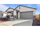 New construction home with a two-car garage and desert landscaping at 3873 S 233Rd Ln, Buckeye, AZ 85326