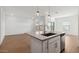 Modern kitchen with island and stainless steel appliances at 3873 S 233Rd Ln, Buckeye, AZ 85326