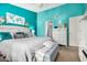 Main bedroom with teal walls, dresser and comfy bedding at 4135 N 17Th St # 8, Phoenix, AZ 85016