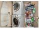 Convenient laundry room with stacked washer and dryer, and storage shelving at 4135 N 17Th St # 8, Phoenix, AZ 85016