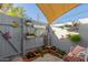 Private backyard patio features a brick garden, seating area, and shade structure at 4135 N 17Th St # 8, Phoenix, AZ 85016