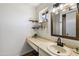 Clean bathroom with updated vanity, mirror, and floating shelves at 4641 W Palo Verde Ave, Glendale, AZ 85302
