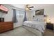 Spacious primary bedroom with plush bed, large TV, and wood-look flooring at 4641 W Palo Verde Ave, Glendale, AZ 85302