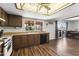 Bright kitchen features wood cabinets, updated flooring, and a view to the backyard at 4641 W Palo Verde Ave, Glendale, AZ 85302