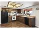 Galley-style kitchen with wood cabinets, and modern appliances at 4641 W Palo Verde Ave, Glendale, AZ 85302