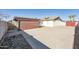 Backyard with garage, concrete patio, and rock garden at 5105 W Wood Dr, Glendale, AZ 85304