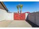 Backyard access with a red wooden gate and block wall at 5105 W Wood Dr, Glendale, AZ 85304