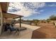 Spacious backyard with a covered patio, spa, and fire pit at 5508 N 190Th Dr, Litchfield Park, AZ 85340