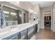 Bathroom with double vanity and walk-in closet access at 5508 N 190Th Dr, Litchfield Park, AZ 85340