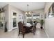 Bright dining room with large windows and a wood table at 5508 N 190Th Dr, Litchfield Park, AZ 85340