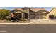 Single-story home with stone accents, two-car garage, and desert landscaping at 5508 N 190Th Dr, Litchfield Park, AZ 85340