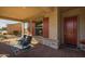 Covered porch with seating area and colorful rug, inviting entryway at 5508 N 190Th Dr, Litchfield Park, AZ 85340