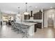 Spacious kitchen with granite countertops, dark cabinetry, and island seating at 5508 N 190Th Dr, Litchfield Park, AZ 85340