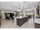 Open kitchen features granite countertops, an island, and modern cabinetry at 5508 N 190Th Dr, Litchfield Park, AZ 85340