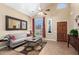 Living room with gray sofa, coffee table, and large window at 62 W Melody Dr, Gilbert, AZ 85233