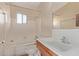 Bathroom with single sink vanity and tub shower at 633 W 1St St, Mesa, AZ 85201