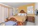 Main bedroom with a large bed and a wooden dresser at 633 W 1St St, Mesa, AZ 85201