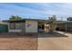 Mid-century modern house with carport and landscaped yard at 633 W 1St St, Mesa, AZ 85201
