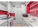 Kitchen features white cabinets, red accents, and a gas range at 633 W 1St St, Mesa, AZ 85201