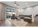 Relaxing living room featuring a large sectional, a walk out balcony and hardwood floors at 6565 E Thomas Rd # 1039, Scottsdale, AZ 85251