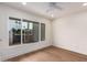 Bedroom with large window, ceiling fan, and light wood floors at 7153 N Via De Paesia --, Scottsdale, AZ 85258