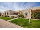 Tan stucco exterior, landscaped lawn, and a walkway leading to the entrance at 7153 N Via De Paesia --, Scottsdale, AZ 85258