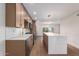 Modern kitchen with an island, light wood cabinets and quartz countertops at 7153 N Via De Paesia --, Scottsdale, AZ 85258