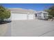 Three car garage and front view of a single story home at 7278 W Via Montoya Dr, Glendale, AZ 85310