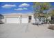 White single story home with a three car garage and desert landscaping at 7278 W Via Montoya Dr, Glendale, AZ 85310