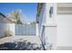 Modern gray gate opens to a white garage and paved driveway at 7278 W Via Montoya Dr, Glendale, AZ 85310