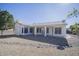 White house exterior with a covered patio and rock landscaping at 7278 W Via Montoya Dr, Glendale, AZ 85310