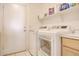 Laundry room with washer, dryer, and storage shelves at 7278 W Via Montoya Dr, Glendale, AZ 85310