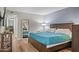 Spacious bedroom with wood flooring and a teal comforter at 7625 E Camelback Rd # B148, Scottsdale, AZ 85251
