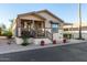Tan single-story home with covered porch and landscaped yard at 9333 E University Dr # 110, Mesa, AZ 85207