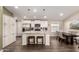 Spacious kitchen with granite island, white cabinetry, and a dining area at 9333 E University Dr # 110, Mesa, AZ 85207
