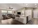 Open floor plan boasts a kitchen island, stainless steel appliances, and a cozy living area at 9333 E University Dr # 110, Mesa, AZ 85207