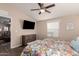 Main bedroom with ceiling fan, dresser, and view of living room at 9333 E University Dr # 110, Mesa, AZ 85207