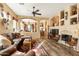 Spacious living room with a leather sectional sofa, fireplace, and built-in shelving at 9574 E Chuckwagon Ln, Scottsdale, AZ 85262