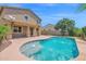 Backyard view showing the pool with surrounding landscaping and covered patio at 9839 E Theia Dr, Mesa, AZ 85212