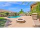 Inviting backyard features a fire pit, sparkling pool, and lush landscaping at 9839 E Theia Dr, Mesa, AZ 85212