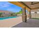View of the pool and backyard landscaping from under the covered patio at 9839 E Theia Dr, Mesa, AZ 85212