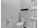 Modern half-bath features pedestal sink, commode, dark shelf and classic fixtures at 9839 E Theia Dr, Mesa, AZ 85212