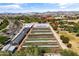 Aerial view of community garden with rows of plants and greenhouses at 9839 E Theia Dr, Mesa, AZ 85212