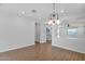 Open dining area with modern lighting, wood-look floors, and easy access to other living spaces at 9839 E Theia Dr, Mesa, AZ 85212