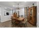Elegant dining room with antique wooden table and cabinet at 9839 E Theia Dr, Mesa, AZ 85212